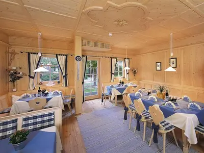 a dining room with tables and chairs in it at Pension Weingarten in Lana