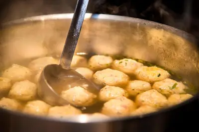 a pot of food with a spoon in it at La Stua in San Cassiano