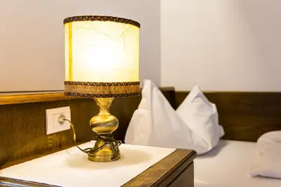 a lamp sitting on top of a table at Hotel Weisses Lamm in Monguelfo