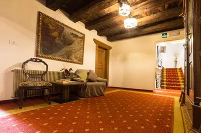 a living room with a couch and a table at Hotel Weisses Lamm in Monguelfo