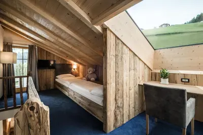 an overhead view of a living room with a couch and a table at Alpenhotel Plaza in Santa Cristina in Val Gardena