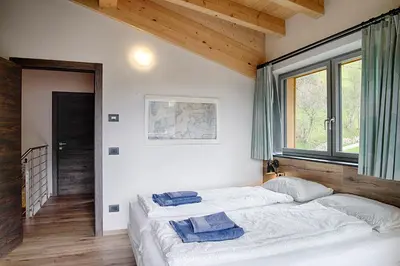 a bedroom with two beds and a window at Klimahouse North in Campitello di Fassa
