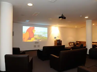 a meeting room with a presentation on a screen at Hotel Sulfner in Avelengo