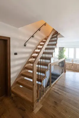 a wooden staircase in a home with a wooden floor at Garni Hotel Tauber in Bressanone