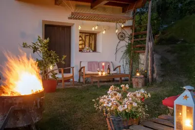 a backyard with a fire pit and a table with candles at Gemangerhof in Bressanone
