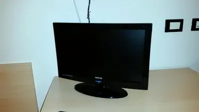 a computer monitor sitting on top of a desk at Hotel Victory in Taio