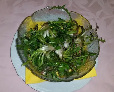 a bowl of vegetables on a plate on a table at Hotel Victory in Taio