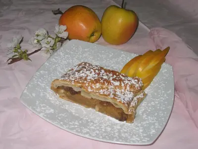 a white plate with a piece of cake and fruit at Hotel Victory in Taio