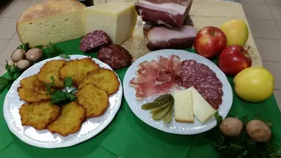 two plates of food on a table with cheese and meat at Hotel Victory in Taio