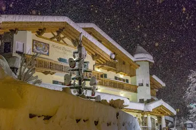 a building with a balcony with a view of a mountain at Pineta Pastry Hotel in Rocca Pietore
