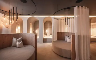 two beds in a room with two beds sidx sidx sidx at Biancaneve Family Hotel in Selva di Val Gardena