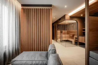 a living room with a couch and a mirror at Residence Cesa Rives in Selva di Val Gardena