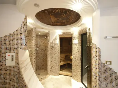 a bathroom with a tub and stairs in a room at Christeinerhof in Santa Cristina in Val Gardena