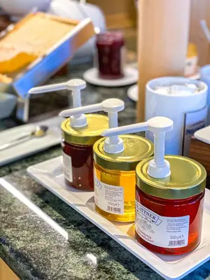 three bottles of paint on a counter in a kitchen at Garni Hotel Bel Vert in Selva di Val Gardena