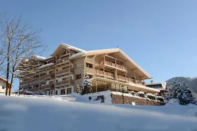 a large building in the snow with snow at Hotel Portillo Dolomites 1966' in Selva di Val Gardena
