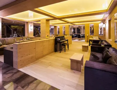 a large room with a kitchen and a living room at Hotel Portillo Dolomites 1966' in Selva di Val Gardena