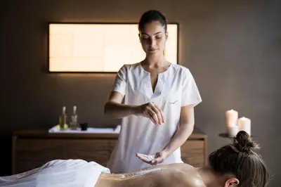 a woman giving a man a massage in a room at Adler Spa Resort Dolomiti in Ortisei