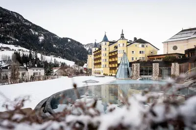 a resort in the mountains with snow on the ground at Adler Spa Resort Dolomiti in Ortisei