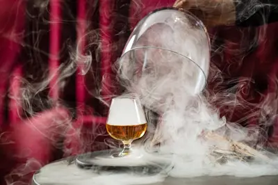 a glass of beer and a snow globe at Grand Hotel Wolkenstein in Selva di Val Gardena