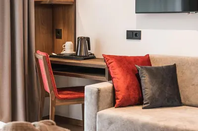 a living room with a couch and a piano at Boutique Hotel Planlim in Ortisei