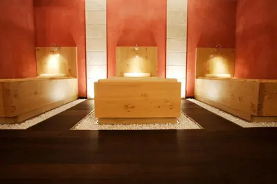 a room with two sinks in a room with red walls at Hotel Condor in Selva di Val Gardena