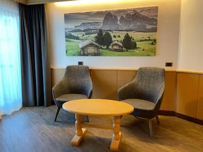 a waiting room with two chairs and a table at Hotel Condor in Selva di Val Gardena