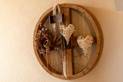 a wooden circle with butterflies hanging on a wall at Residence Pollingerhof in Merano