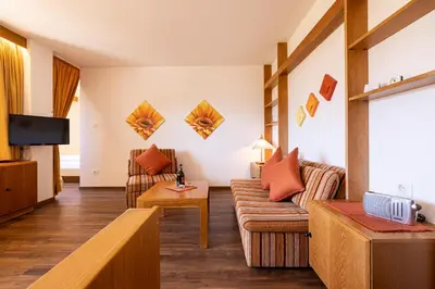 a living room with a couch and a tv at Residence Pollingerhof in Merano