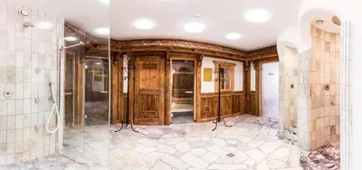 a bathroom with a shower and a glass door at Hotel Goldene Rose in Monguelfo
