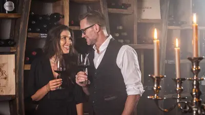 a man and a woman holding glasses of wine at SOLEA SÜDTIROL Boutique Hotel in Schenna