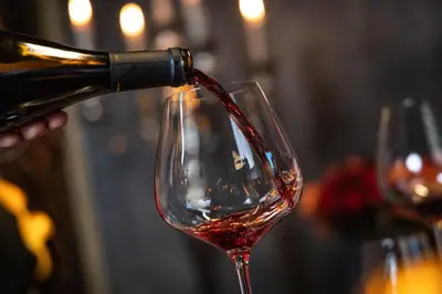 a person pouring wine into a wine glass at SOLEA SÜDTIROL Boutique Hotel in Schenna