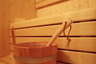 a wooden cup with a straw in it next to a piano at Apartments Oberdorner in Lagundo