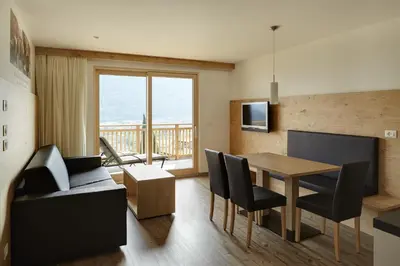 a living room with a table and a dining room at Apartments Oberdorner in Lagundo
