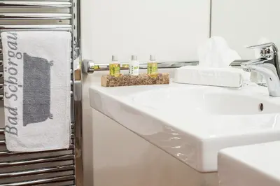 a bathroom with a white sink and a mirror at Hotel Bad Schörgau in Sarntal