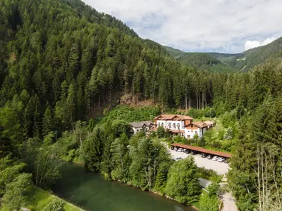 a town in the mountains next to a river at Hotel Bad Schörgau in Sarntal