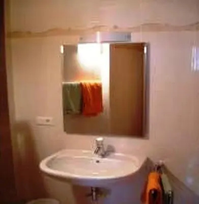 a bathroom with a sink and a mirror at Hubengut Apartments in Lana