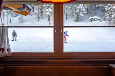 a window with a view of a snow covered yard at Hotel Somont in Selva di Val Gardena