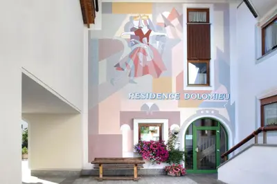 a mural on the side of a building at Residence Dolomieu in San Cassiano