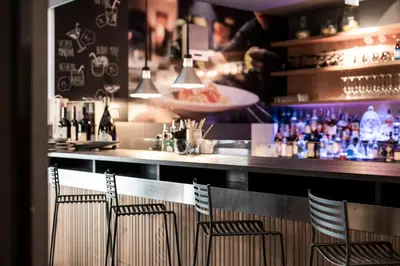 a restaurant with a table with an ipad on a stand at Alpstay - Smart Hotel Saslong in Santa Cristina in Val Gardena