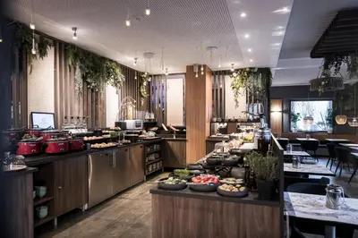 a buffet line with different types of food on display at Alpstay - Smart Hotel Saslong in Santa Cristina in Val Gardena