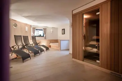 a group of chairs sitting in a living room at Residence Cesa Sassela in Ortisei