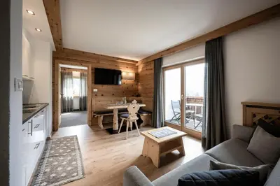 a living room with a couch and a table at Residence Cesa Sassela in Ortisei