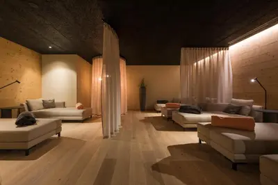 a large living room with couches and tables in a room at Hotel Kiendl in Schenna