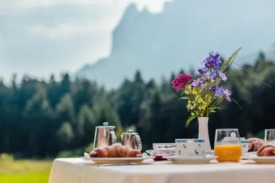 a window view of a building with a mountain in the background at Hotel Waldsee in Fiè