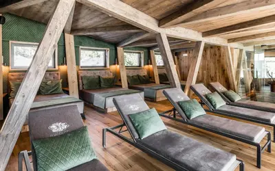 a room with chairs and wooden ceilings and wooden floors at Hotel Waldsee in Fiè