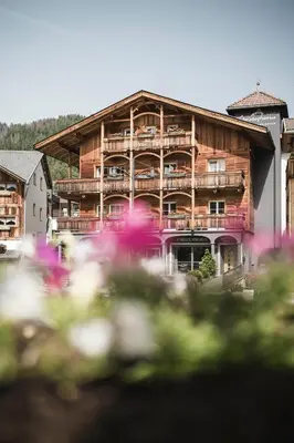 a large wooden building with balconies on it at Christophorus Mountain Residence in San Vigilio Di Marebbe