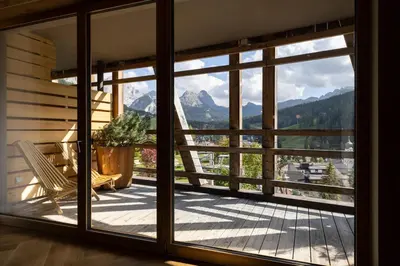 a bedroom with a bed and a wooden ceiling at Hotel Fanes in San Cassiano