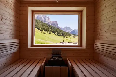 a room with a window with a view of a mountain at Hotel Fanes in San Cassiano