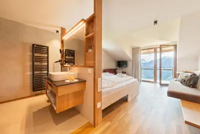 a large bathroom with a sink and a mirror at Herol - my mountain retreat in Luson