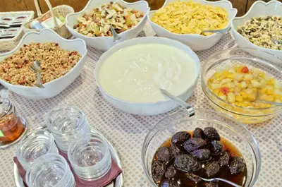 a table topped with bowls of food and other foods at Pension Lafod in Tirolo